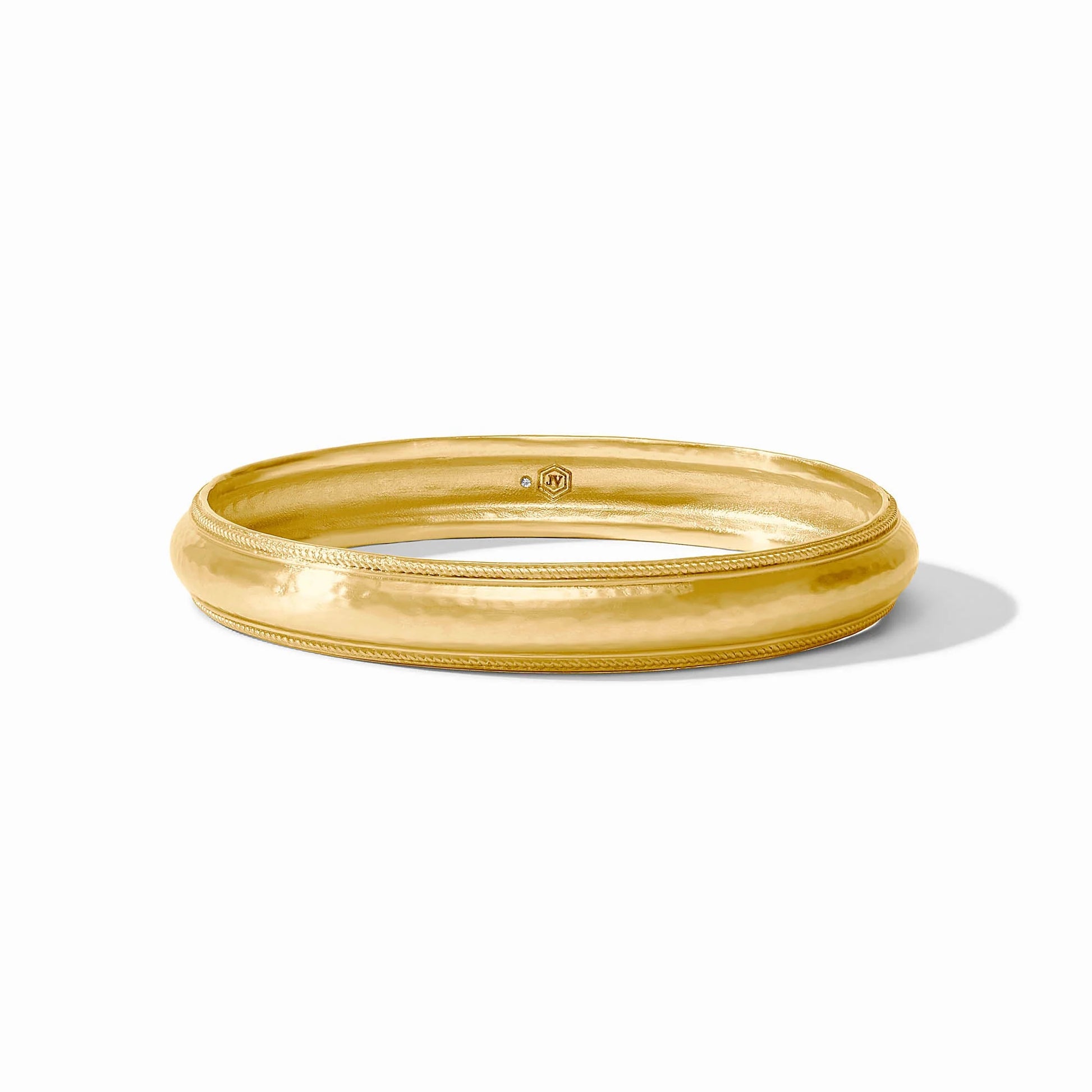 Cannes Bangle Gold bangle on a white background