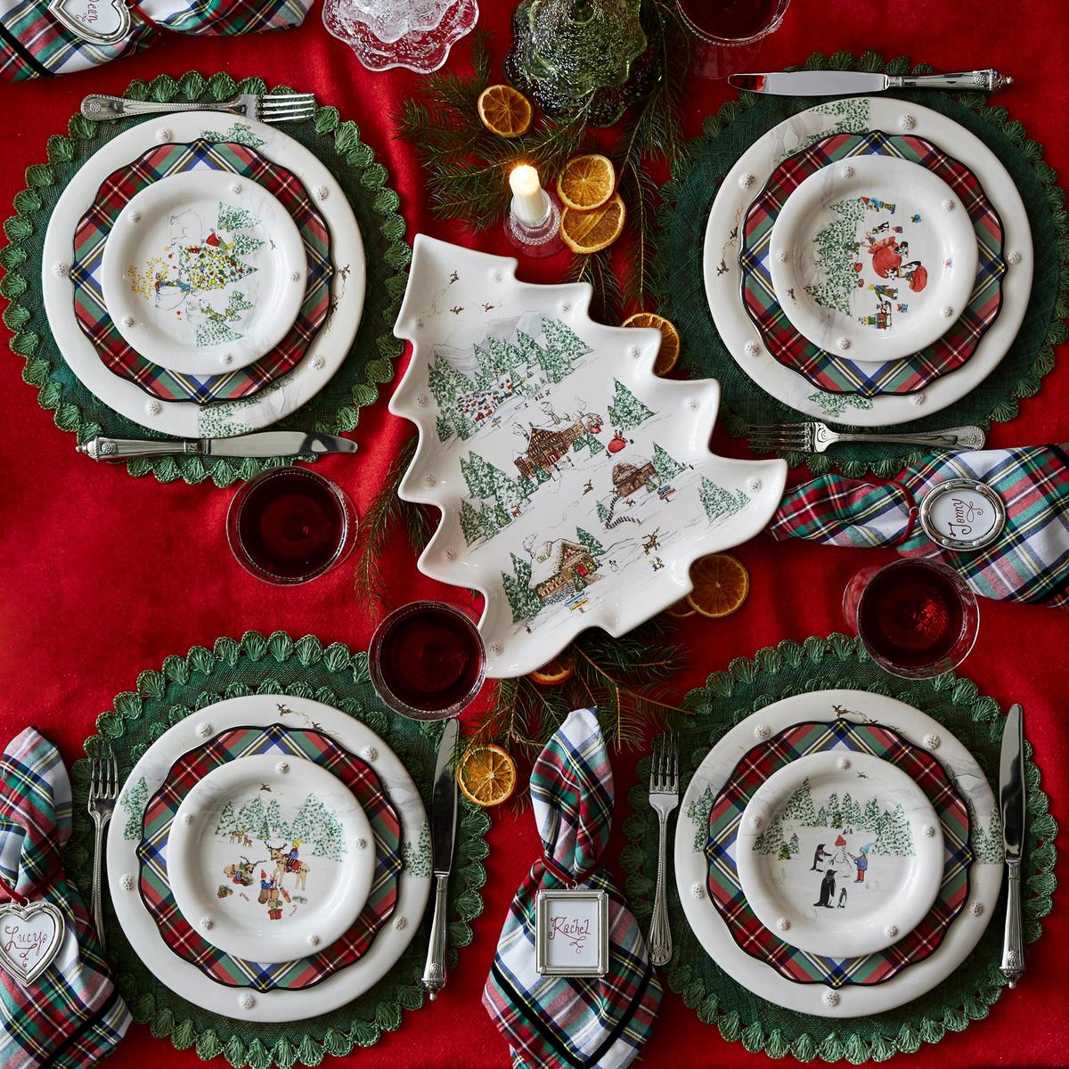 Christmas-themed table setting with plaid plates, tree-shaped centerpieces, and red tablecloth.