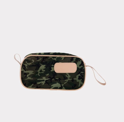 A person holding a black and brown vinyl coated canvas shaving kit with natural leather trim and straps, featuring a zippered closure and the brand name 'Lewis' on the front.